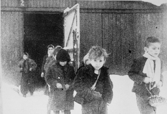 january-1945-child-survivors-walk-out-of-the-childrens-barracks-in-auschwitz